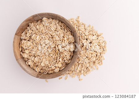 dry rolled oatmeal in bowl isolated dry rolled oatmeal in bowl isolated 123084187