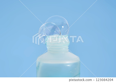 Shampoo pouring out of a small tube on a blue background. Texture. Shampoo pouring out of a small tube on a blue background. Texture. 123084204
