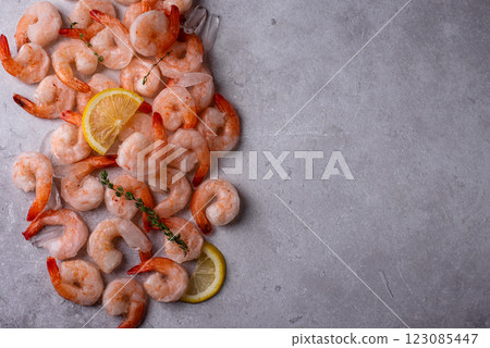 Frozen uncooked prawns or shrimps with lemon Frozen uncooked prawns or shrimps with lemon 123085447