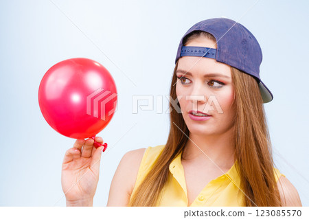Teenage girl with red balloon. 123085570