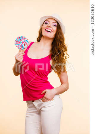 Woman holds colorful lollipop candy in hand Woman holds colorful lollipop candy in hand 123085610