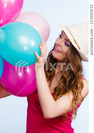 Woman playing with many colorful balloons 123085612