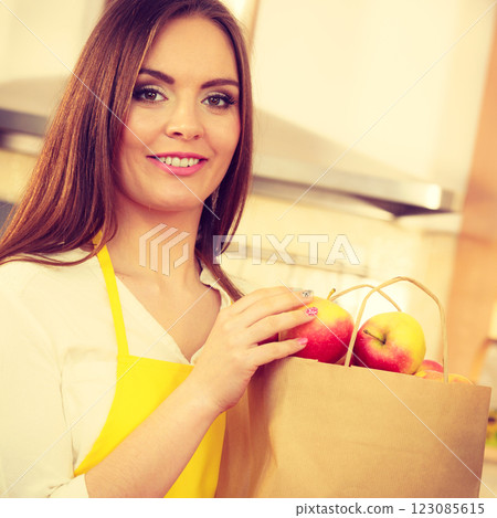Woman housewife in kitchen with many fruits 123085615