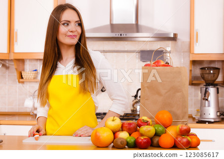 Woman housewife in kitchen with many fruits 123085617