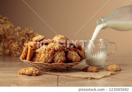 Oatmeal cookies and milk sit on a kitchen table. Oatmeal cookies and milk sit on a kitchen table. 123085692