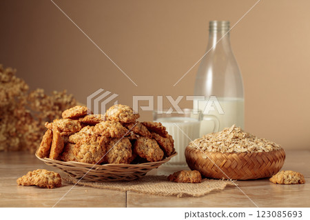 Oatmeal cookies and milk on a kitchen table. 123085693