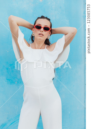 Beautiful Brunette Woman in White Suit on Blue Background 123085753