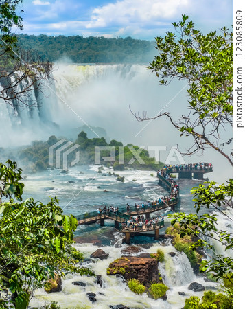 Stunning view of Iguazu Falls with tourist walkway and lush greenery 123085809