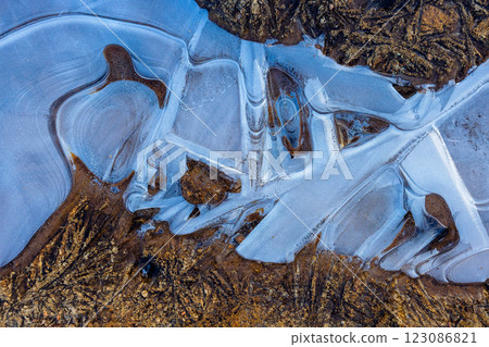 Frozen water on the ground, pattern of ice 123086821