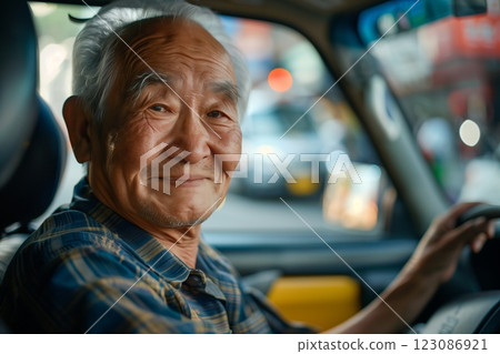 A smiling elderly man driving a vehicle, embodying wisdom and experience in life. 123086921