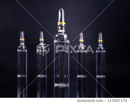 Ampoules with medicine on glossy black background 123087170