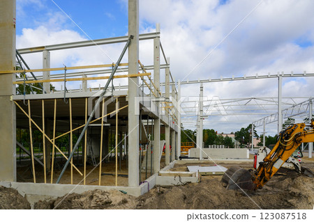 Construction site of a new modern factory reinforced concrete and metal structure building frame Construction site of a new modern factory reinforced concrete and metal structure building frame 123087518