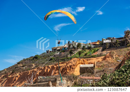 Paraglider pilot at Canoa Quebrada Beach at Aracati in Ceara, Brazil. Bay Coastline 123087647