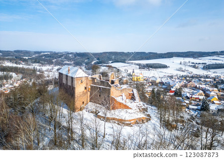 Pecka castle stands majestically in a snowy landscape, showcasing its medieval architecture. Surrounded by tranquil winter scenery, it highlights the beauty of Czechia's winter season. Pecka castle stands majestically in a snowy landscape, showcasing its medieval architecture. Surrounded by tranquil winter scenery, it highlights the beauty of Czechia's winter season. 123087873