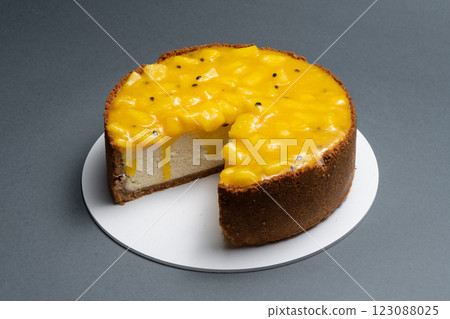 Delicious mango cheesecake with a rich creamy layer and a vibrant mango topping, perfect for dessert lovers and special occasions Delicious mango cheesecake with a rich creamy layer and a vibrant mango topping, perfect for dessert lovers and special occasions 123088025