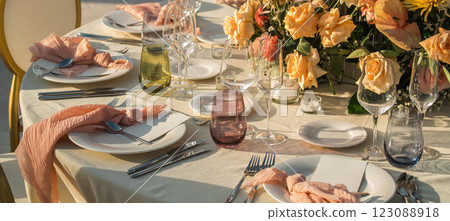 Banner Wedding banquet concept. Chairs and round table for guests, served with cutler and, flowers and crockery and covered with a tablecloth 123088918