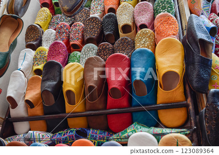 Slippers or sandals of many colors hung from street stalls in Marrakech's souk Slippers or sandals of many colors hung from street stalls in Marrakech's souk 123089364