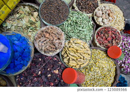 Curry in root and various spices displayed in a local bazaar market in Marrakesh 123089366