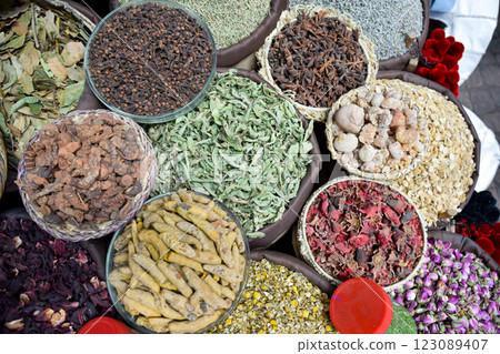 Curry in root and various spices displayed in a local bazaar market in Marrakesh Curry in root and various spices displayed in a local bazaar market in Marrakesh 123089407
