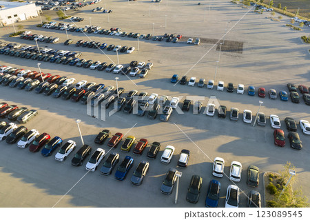 View from above of dealers outdoor parking lot with many brand new cars in stock for sale. Concept of development of american automotive industry View from above of dealers outdoor parking lot with many brand new cars in stock for sale. Concept of development of american automotive industry 123089545