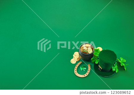 St. Patrick's Day Symbols. A festive green scene with a leprechaun hat, gold coins, horseshoe St. Patrick's Day Symbols. A festive green scene with a leprechaun hat, gold coins, horseshoe 123089652