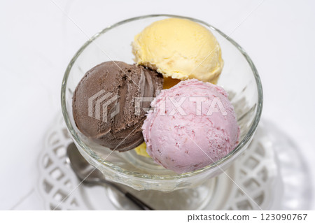 Close-up of a refreshing dessert with three colorful ice creams lined up 123090767