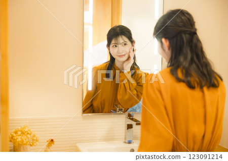 Woman getting dressed in the washroom Woman getting dressed in the washroom 123091214