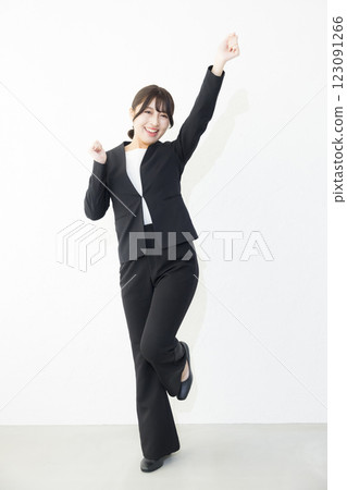 Smiling woman standing against white background 123091266