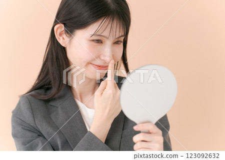 A woman in a suit looking in the mirror A woman in a suit looking in the mirror 123092632