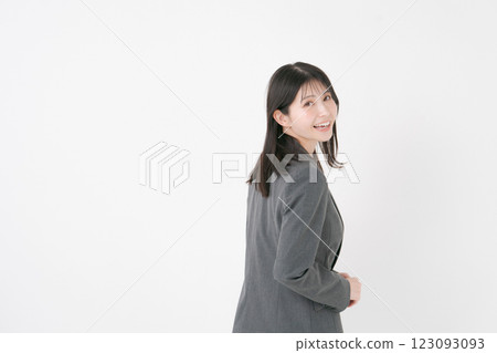A woman in a suit looking back A woman in a suit looking back 123093093