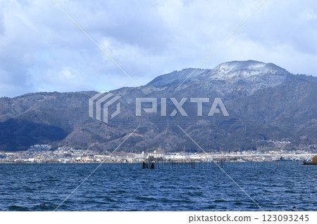 The surface of Lake Biwa choppy from strong winds and Mount Hiei covered in snow 123093245