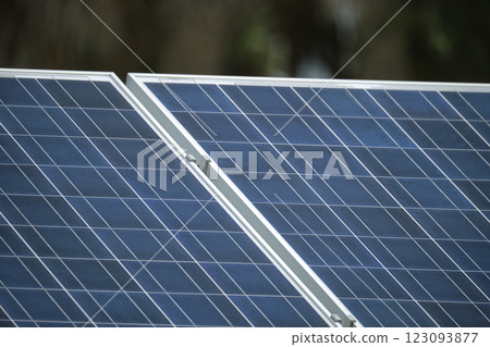 Solar photovoltaic panels mounted on stand-alone frame on backyard ground for generating of clean ecological electric energy. Concept of autonomous house Solar photovoltaic panels mounted on stand-alone frame on backyard ground for generating of clean ecological electric energy. Concept of autonomous house 123093877