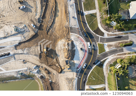 Roadworks construction site at roundabout intersection on American highway. Development of city circular transportation crossroads Roadworks construction site at roundabout intersection on American highway. Development of city circular transportation crossroads 123094063