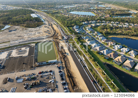 Roadworks construction site at roundabout intersection on American highway. Development of city circular transportation crossroads 123094066