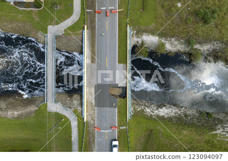 Road construction. Repair of destroyed bridge after hurricane flooding water washed away asphalt in Florida. Construction roadwork site 123094097