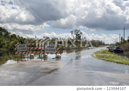 Road closed for roadworks and danger of flooding with warning signs blocking driving of cars Road closed for roadworks and danger of flooding with warning signs blocking driving of cars 123094107