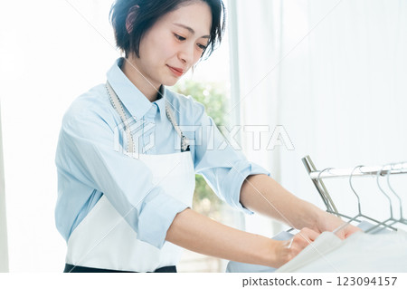 A woman hanging laundry to dry indoors A woman hanging laundry to dry indoors 123094157