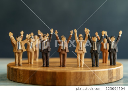 Wooden miniature businessmen standing in a row (organizational power, hierarchy, leadership, unity) 123094504