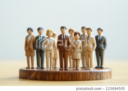 Wooden miniature businessmen standing in a row (organizational power, hierarchy, leadership, unity) Wooden miniature businessmen standing in a row (organizational power, hierarchy, leadership, unity) 123094505