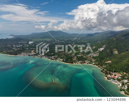 Serene beach with white sand and surrounding greenery extending into the ocean with vibrant tropical colors. Koh Samui, Thailand. 123094896