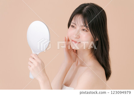 Woman looking in the mirror Woman looking in the mirror 123094979