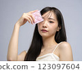 Woman applying makeup, foundation, brush and compact 123097604