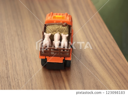 Child lorry with pigs on table. Vintage developmental toy. Farm and animals. Child lorry with pigs on table. Vintage developmental toy. Farm and animals. 123098183