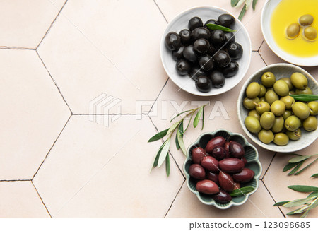 Variety of fresh olives with olive oil displayed elegantly Variety of fresh olives with olive oil displayed elegantly 123098685