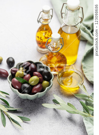 Assorted olives and olive oil on rustic table 123098686
