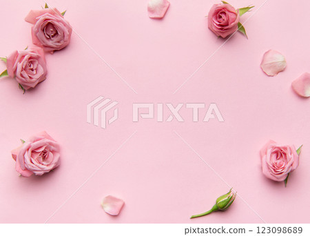 Pink roses and petals forming frame on pink background 123098689