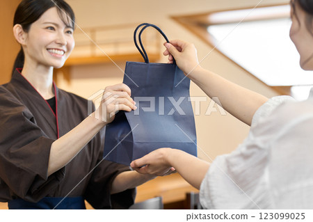 A restaurant employee handing out a product A restaurant employee handing out a product 123099025