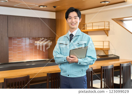 A man in work clothes visiting a restaurant 123099029