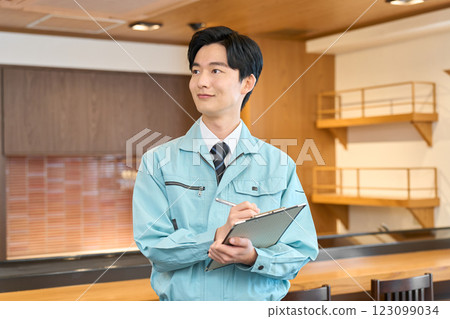 A man in work clothes inspecting a restaurant A man in work clothes inspecting a restaurant 123099034