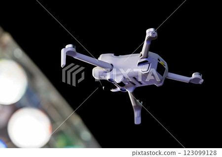 White drone flying at night White drone flying at night 123099128